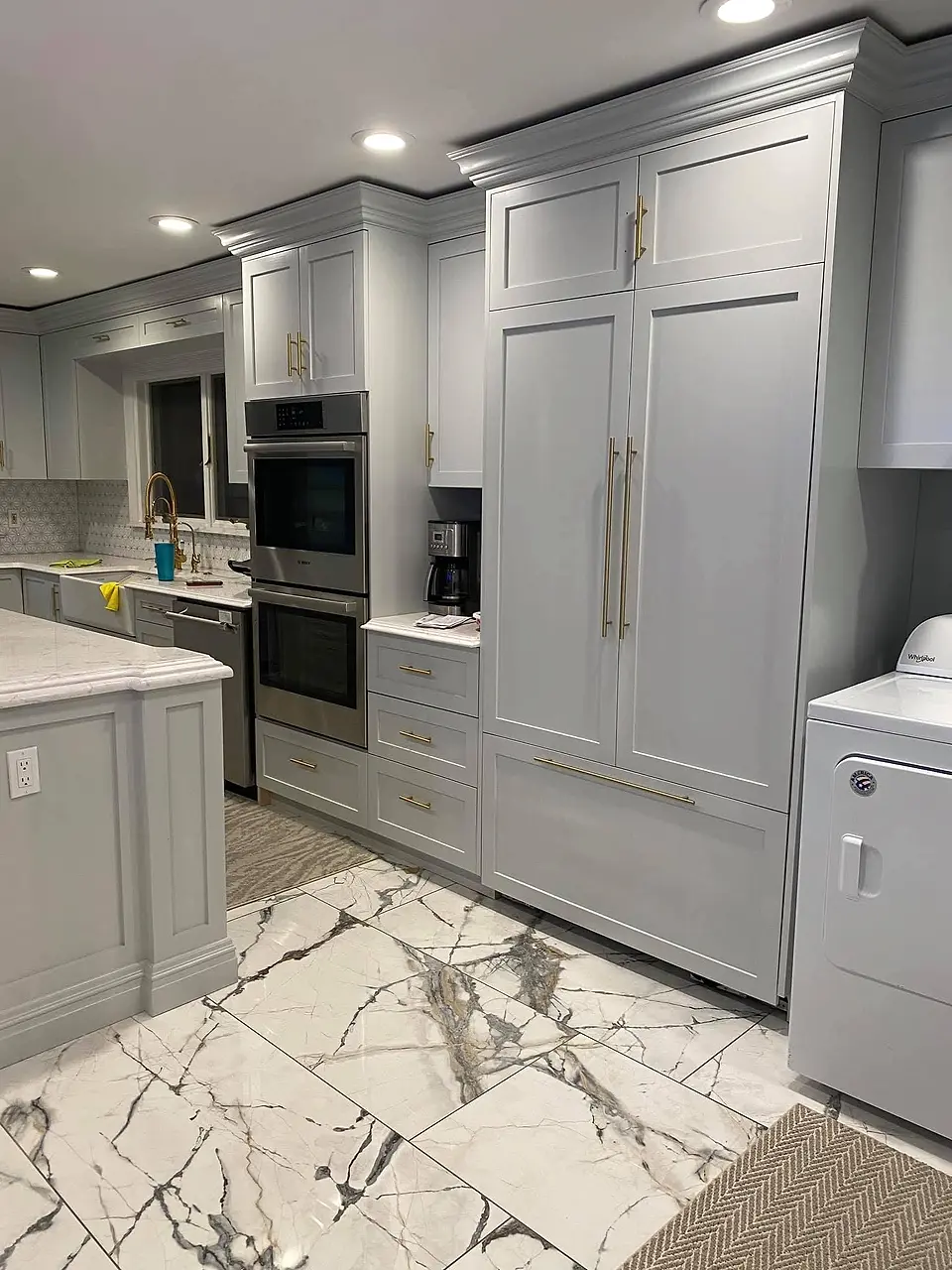 Gray shaker kitchen, paneled fridge wall